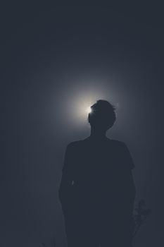 No colors. Dark and low angle image of someone.