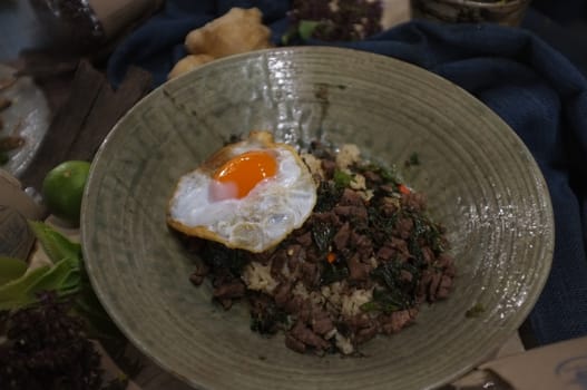 Rice topped with stir-fried beef and basil and fried egg , Concept healthy food , organic food