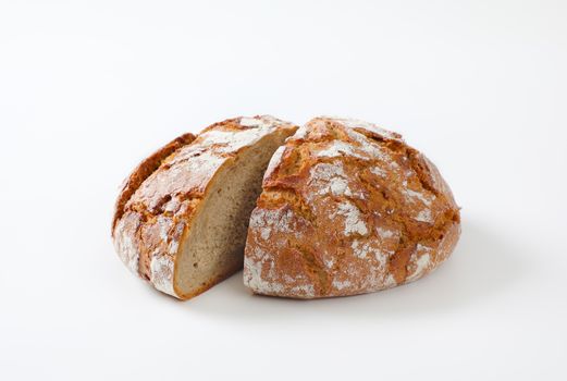Loaf of rustic bread cut into halves