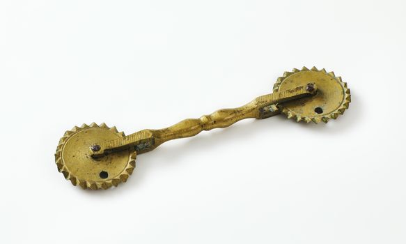 Antique pasta and pastry cutter with two fluted wheels