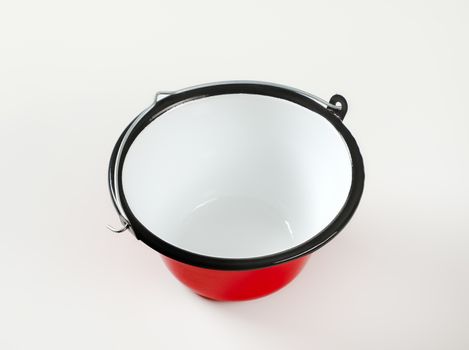 Red enamel cauldron / cooking pot used for outdoor cooking over an open fire and serving goulash, soups, sauces, mulled wine, dips, cheese fondue