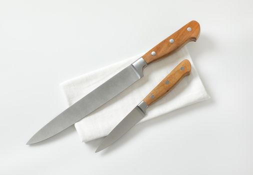 Kitchen utility knife and Paring knife on white napkin