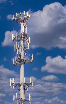 A cellular phone tower against a blue sky