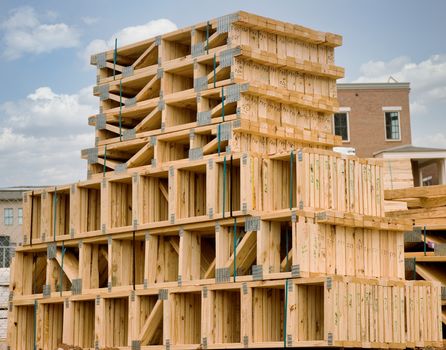 Wood roof trusses stacked up at a construction site