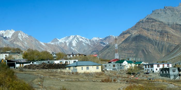 Village at Foothill of Himalayas. Small Villages In The Foothills Of Himalayan picturesque valley. A beautiful indian landscape of a town city at foothills of snow capped Mountain ranges. Kaza India