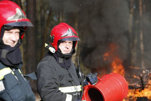 Firefighters preparing to extinguish forest fire.Extinguish the fire. Work firefighter. Fight with fire. Dangerous profession