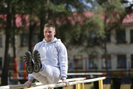 Physical culture lesson. A young gymnast. Sports training of soldiers