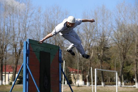 Jump over the obstacle course.The athlete jumps over the barrier.Physical education lesson.