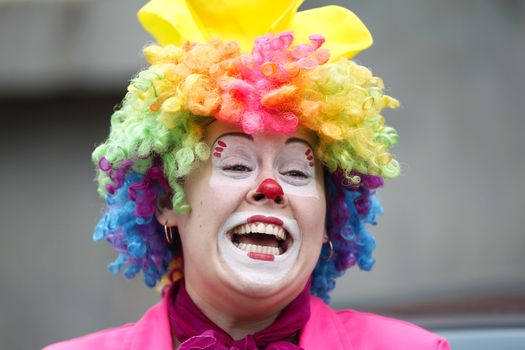 A woman clown laughs gaily.Joyful children's clown