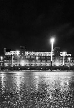 Black and white night shot of the central depot of the LVR Industrial Museum, Peter-Behrens-Bau, in Oberhausen, Germany. Bauhaus and the New Objectivity architecture style.