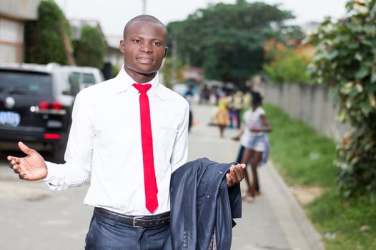 Young man standing out with arms outstretched to welcome someone.