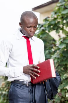Young student holding a book and ready to open it.