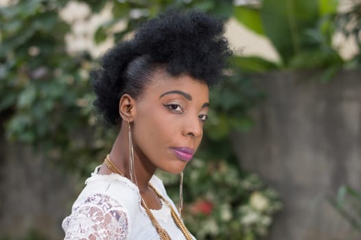 Portrait of young African woman posing in a garden.