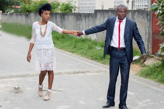 Young man pulling his companion by the hand as a sign of love.