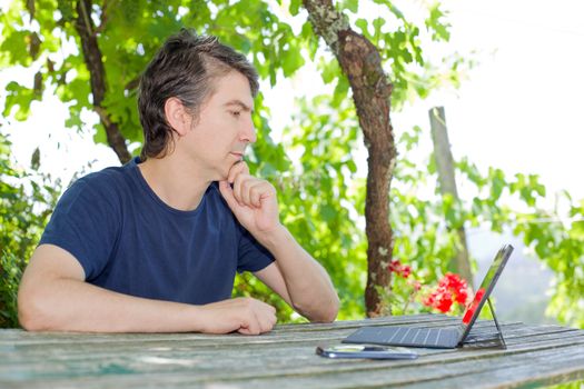 casual man working with a tablet pc, outdoor