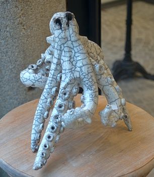 Ceramic figure of octopus on wooden table