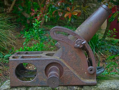 Old vintage rusted small mortar canon with greenery in background