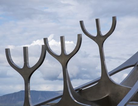 The Sun Voyager Monument on the waterfront in Reykjavik, Iceland. Cloudy weather.