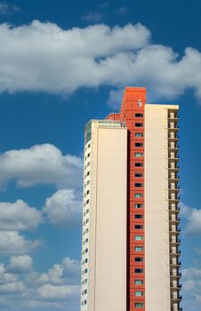 A high rise condo tower against blue sky