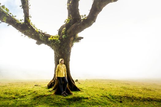 Traveller woman feeling the power of the nature at an ancient forest