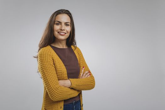 Shot of a beautiful young woman over a gray background