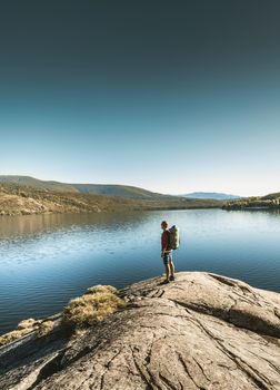 Shot of a man hiking near a beautiful lake