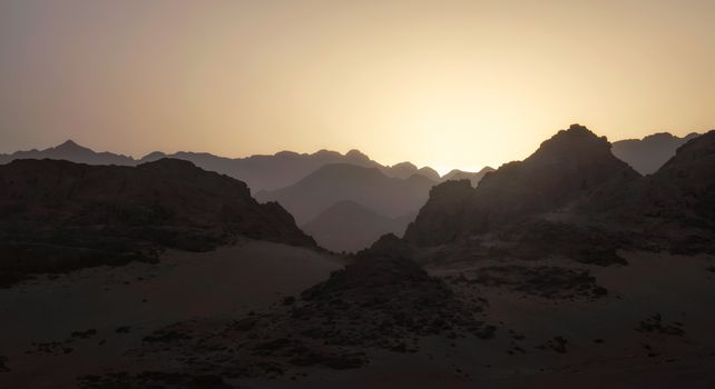 night desert landscape with rocky mountains and sunset sky with clouds in Sharm El Sheikh Egypt