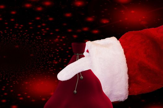 hand of Santa claus holding his bag isolated on a christmas background with red stars