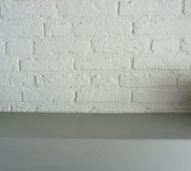 empty surface grey wooden table top with a white brick wall background