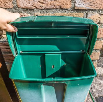 Empty open green plastic mailbox with nothing inside background texture