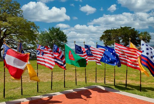 An array of historic early American flags at a public park