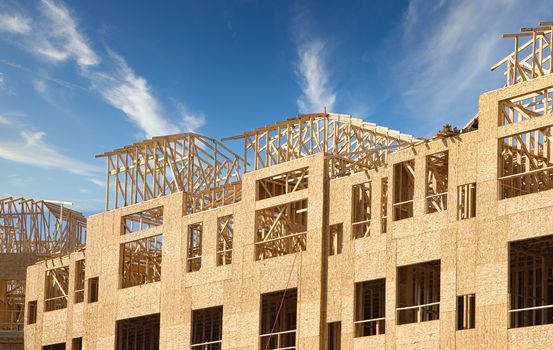 A new apartment complex being framed with wood and plywood lumber