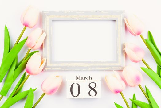 Happy Women's Day, Mother's Day and Valentine's Day concept. top view flat lay Tulip flower and photo frame on white background, copy space for your text