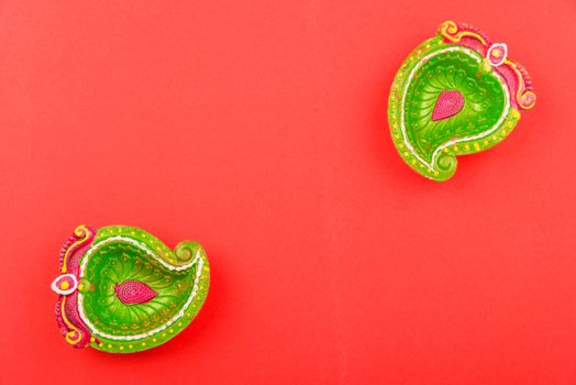 Happy Diwali Day, Flat lay top view Colorful Clay Diya lamps on red background and copy space for your text