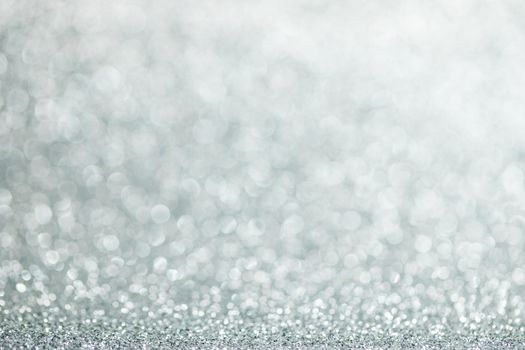 Shiny silver bokeh glitter lights abstract background, Christmas New Year party celebration concept