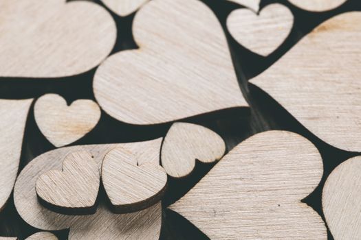 Many wooden colorless hearts background, two special ones true love concept