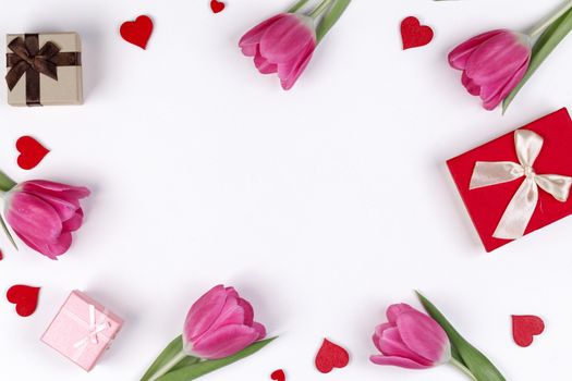 Pink tulip flowers gifts red hearts and gifts composition isolated on white background top view with copy space. Valentine's day, birthday, wedding, Mother's day concept. Copy space