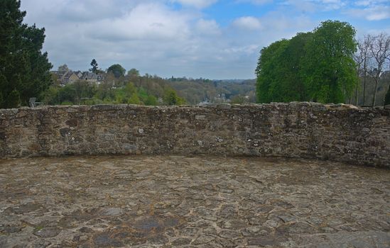 Top of stone fortress tower and landscape behind it in Dinan, France