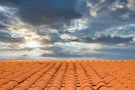 A roof of red quarry tiles against a blue sky