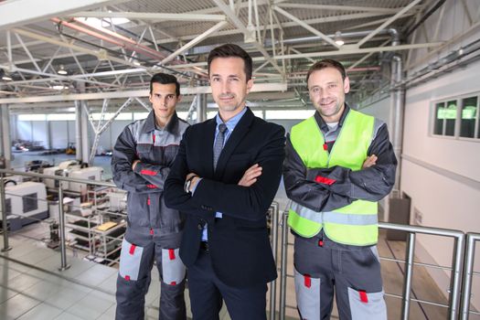 Portrait of business man and workers at factory teamwork cooperation concept