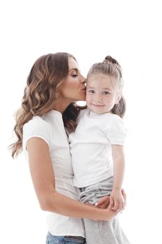 Mother kisses her daughter isolated on white background