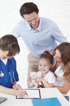 Happy female doctor exam child, smiling happy healthy family