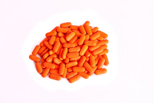 Orange pills on a white background