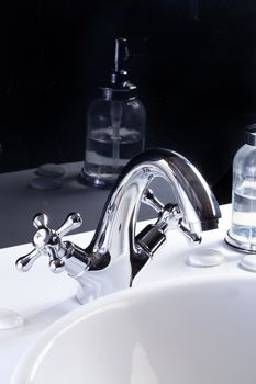 Metal water mixer and porcelain sink