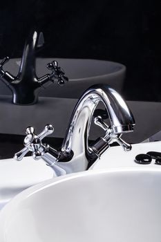 Metal water mixer and porcelain sink