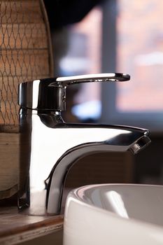 Metal water mixer and porcelain sink