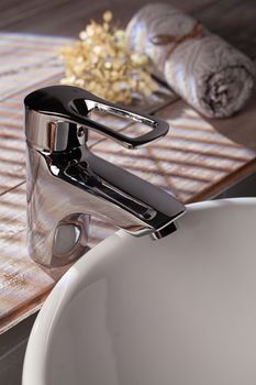 Metal water mixer and porcelain sink