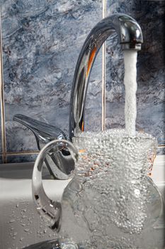 Metal water mixer and porcelain sink