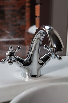 Metal water mixer and porcelain sink