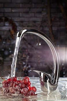 Water mixer and fruits on a studio background